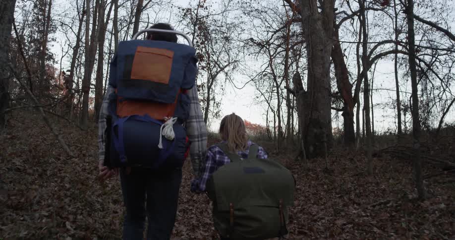 A man leads a child uphill hiking