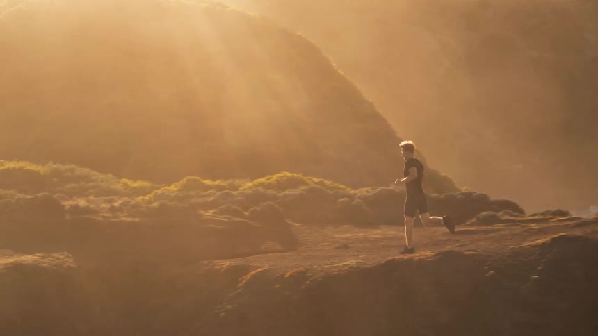 A man jogs atop a hill