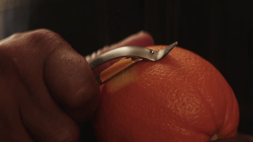 Someone is peeling an orange