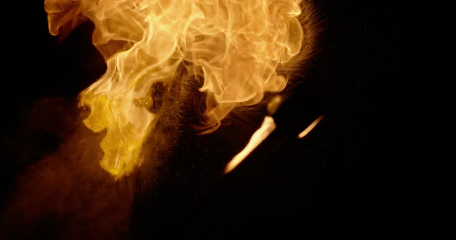 A torch shoots fire into the night sky