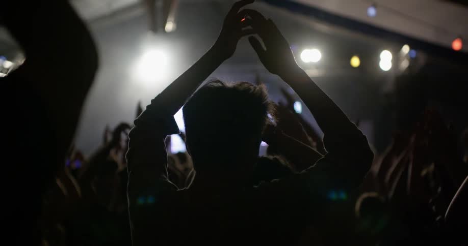 People cheer on their band on stage