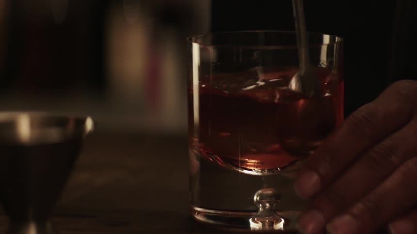 A man is stirring a drink
