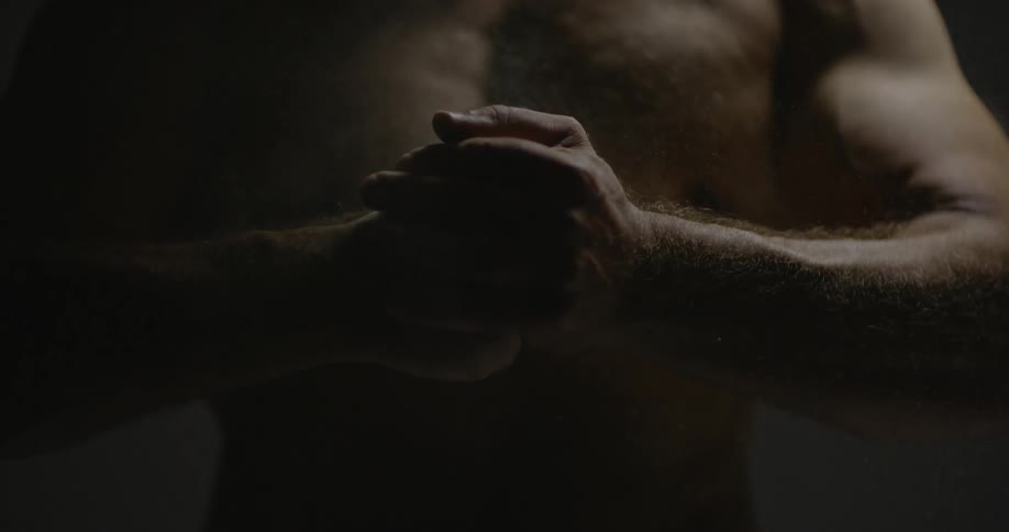 A man is slamming his fist into his palm