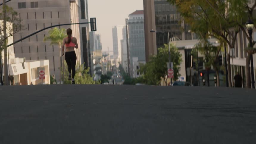 A woman runs down the street