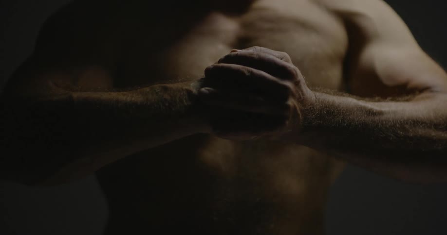 A man is slamming his fist into his palm