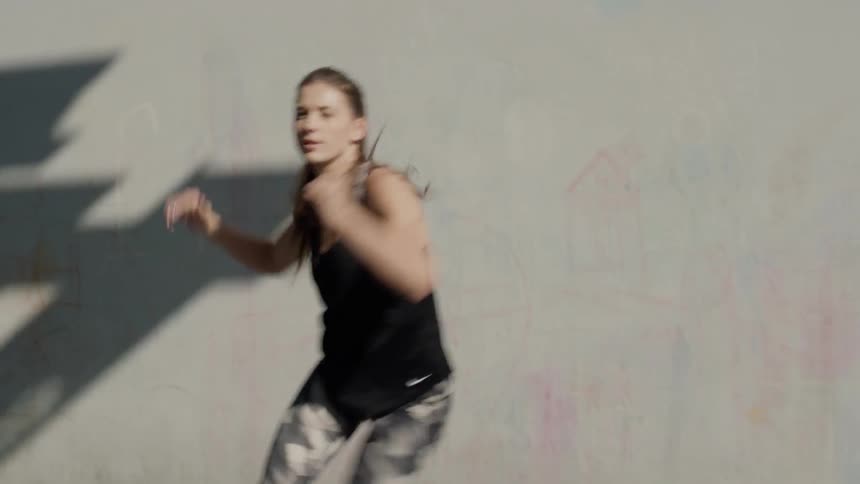 A woman is exercising in the sunlight