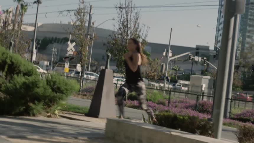A woman runs fast around the corner