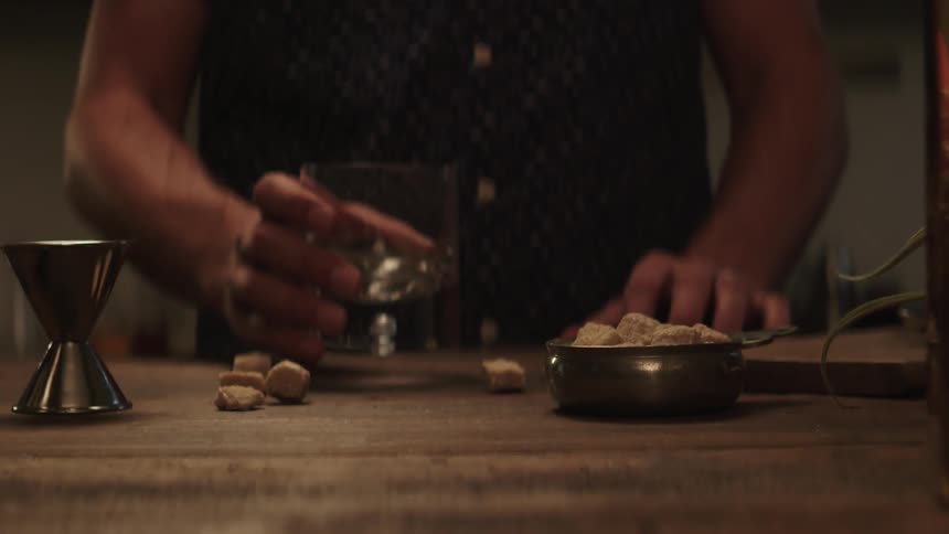 A man puts a glass down on the table