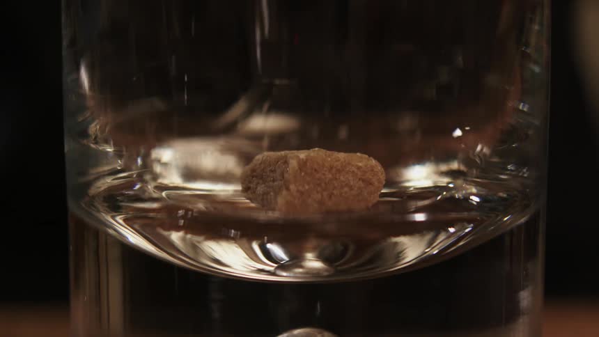 An item is dropped in a small glass