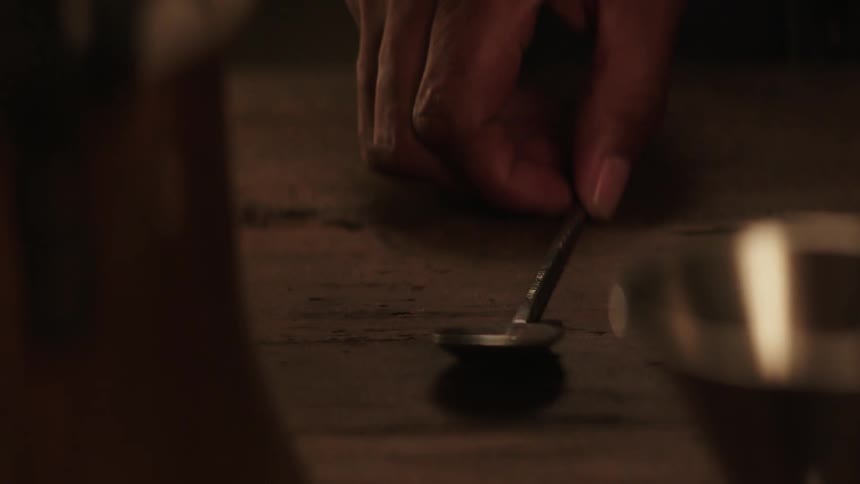 Person picks up a spoon off a table