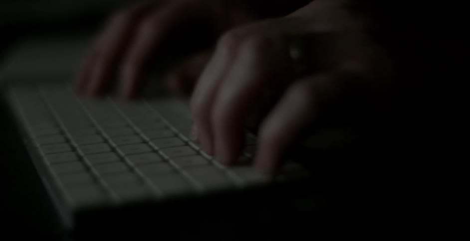 A person types on a white keyboard fast