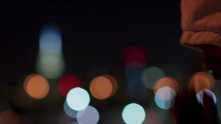 A man shadow boxes outside at night