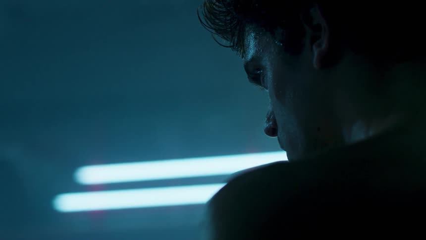 Man sits in a brightly lit room