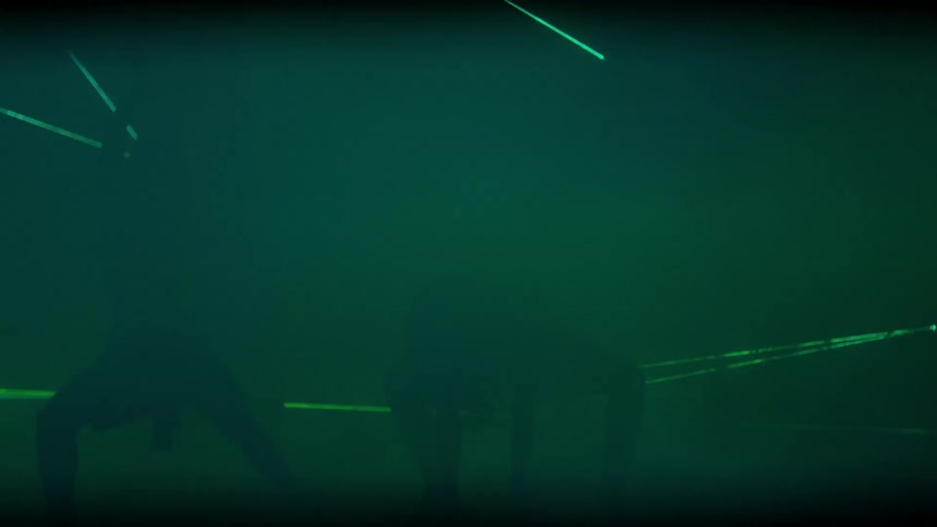 Two people dance as lights flash around them