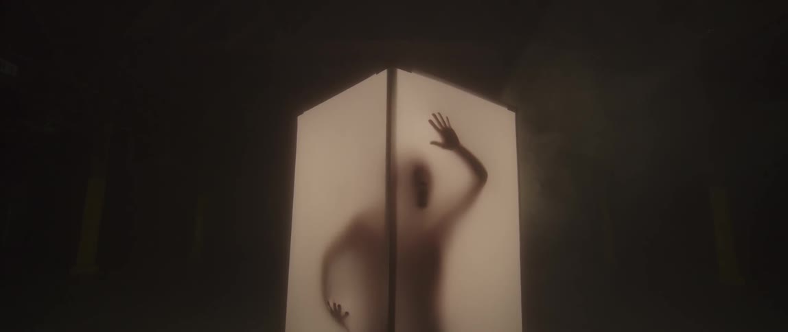 Person touches the walls of a translucent box