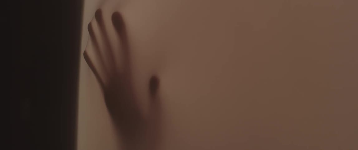 A man presses up against a lit screen
