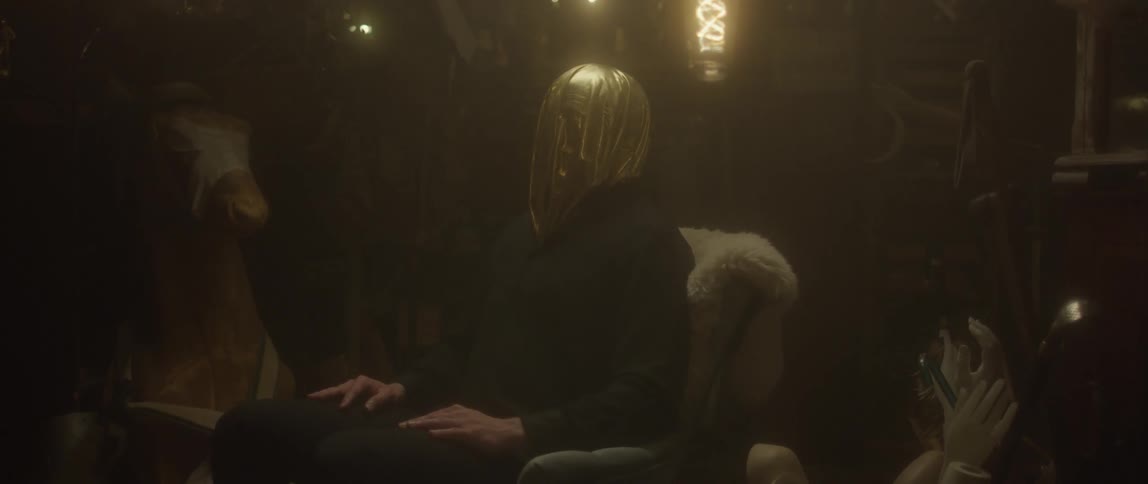 Person sitting in a chair with head covered in silver cloth