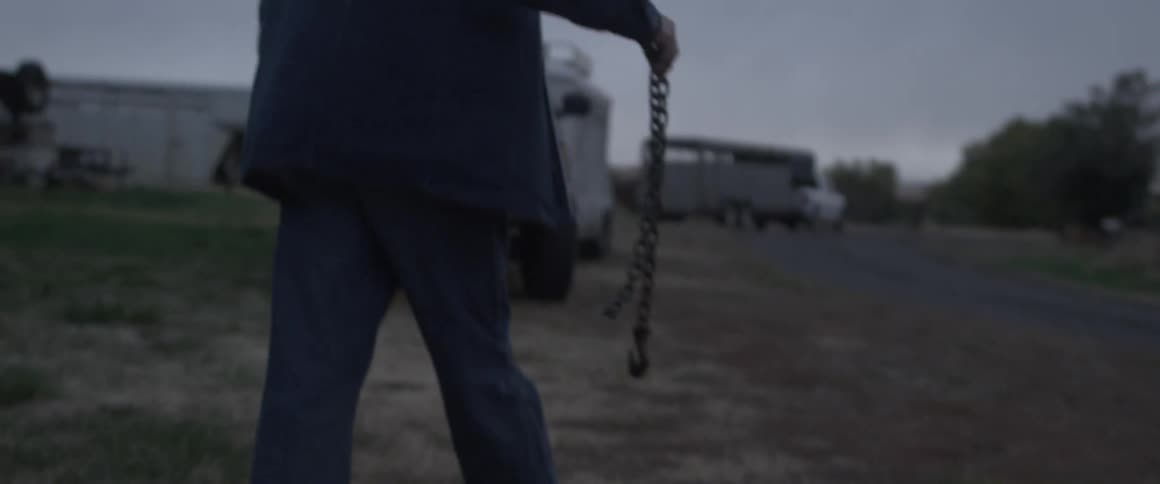 Man carries a chain as he walks