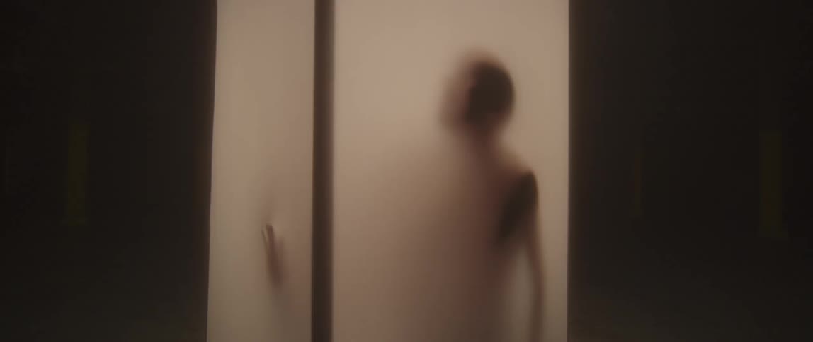 Silhouette of a person touching screens