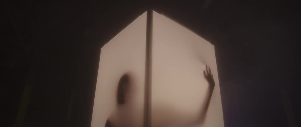 A man presses up against a lit screen