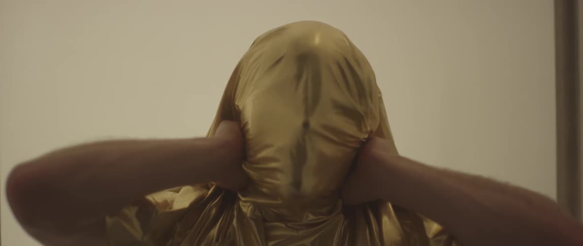 A person tightens the sheet over their head