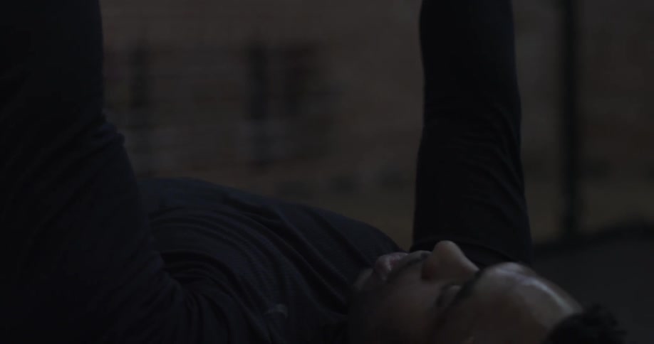 A man is lifting two dumbbells