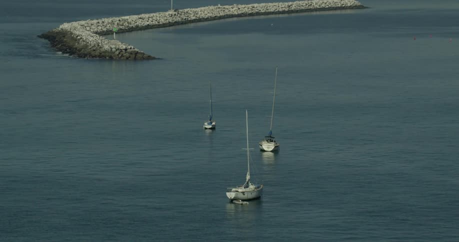 Boats travel in the water off the coast of California