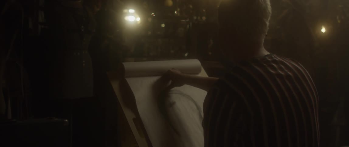 An artist draws using charcoal