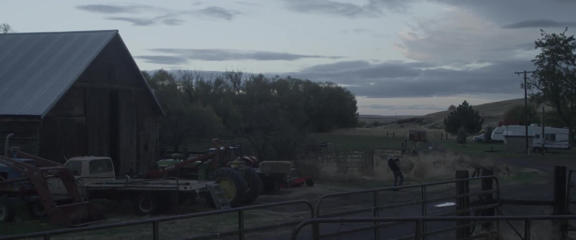 Someone is carrying bales of hay