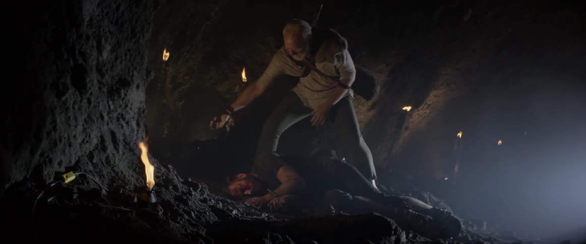 A captive man being rescued tries to reattach his rope to a cave wall