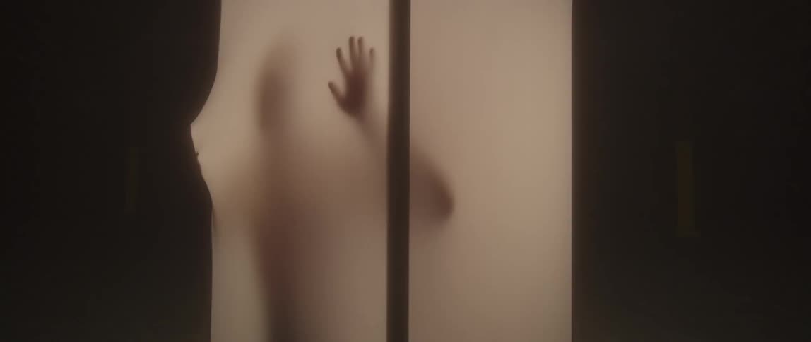 Person inside a soft sided enclosure presses his hands against the sides