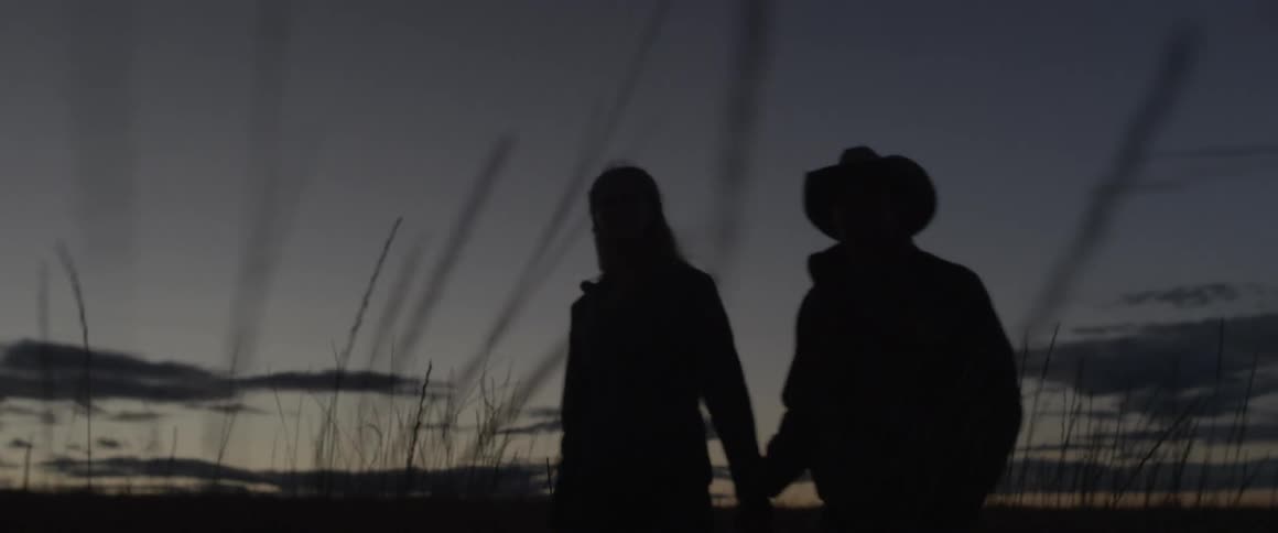 Man and woman hold hands as they walk
