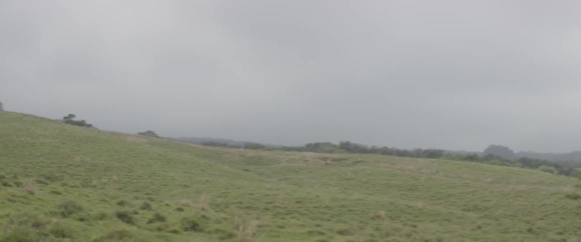 A hilly area is shown on a cloudy day