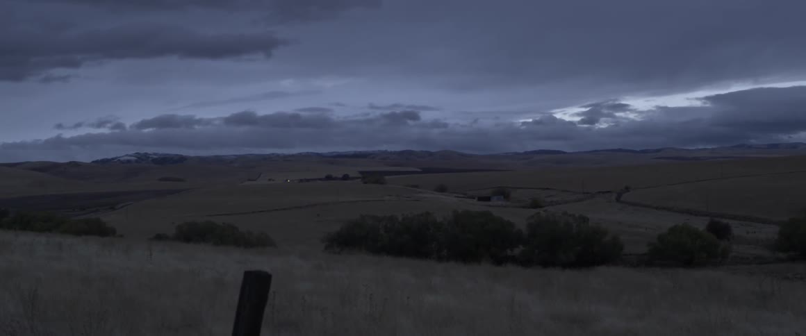 Cloudy night sky over a valley