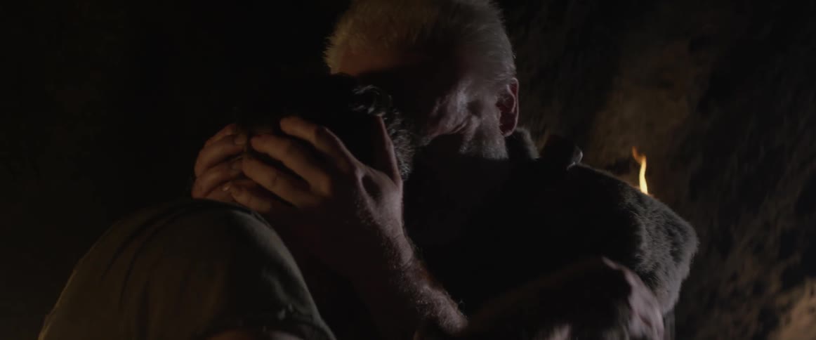 An injured man embraces his father