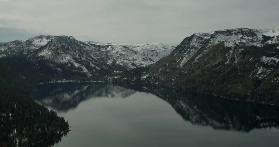 The water is calm near the mountains in Lake Tahoe, California