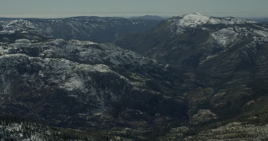 Snow tipped mountains on a cloudy day
