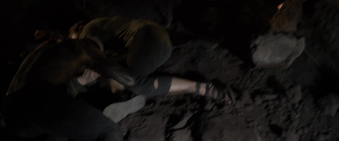 A man is raising a sword and gets hit and knocked to the ground