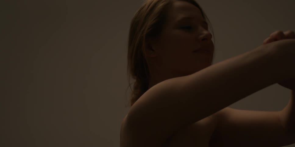 Woman standing by herself in a dimly lit room