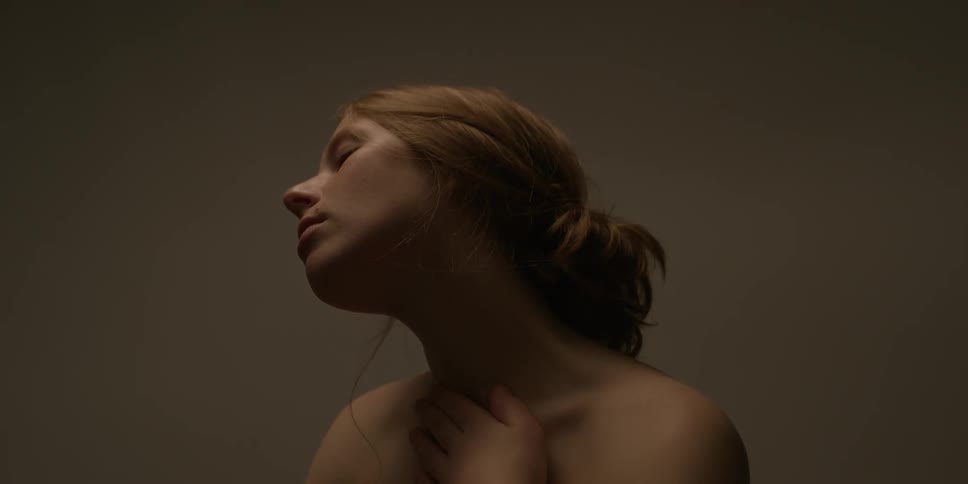 A woman rubs her neck