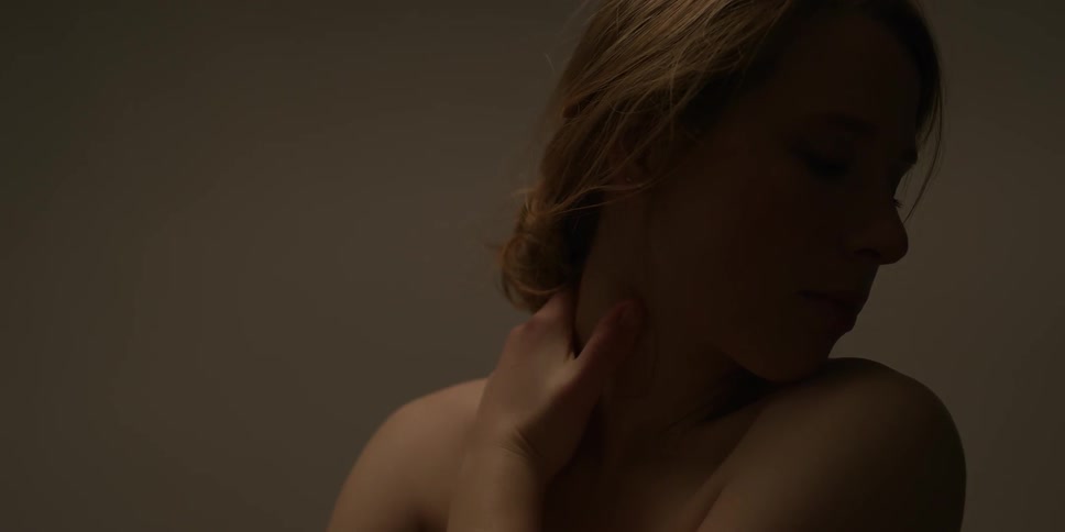A woman rubs her shoulders
