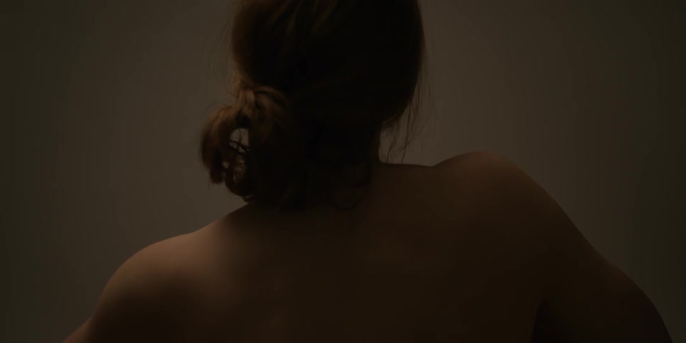 A woman shrugs her shoulders