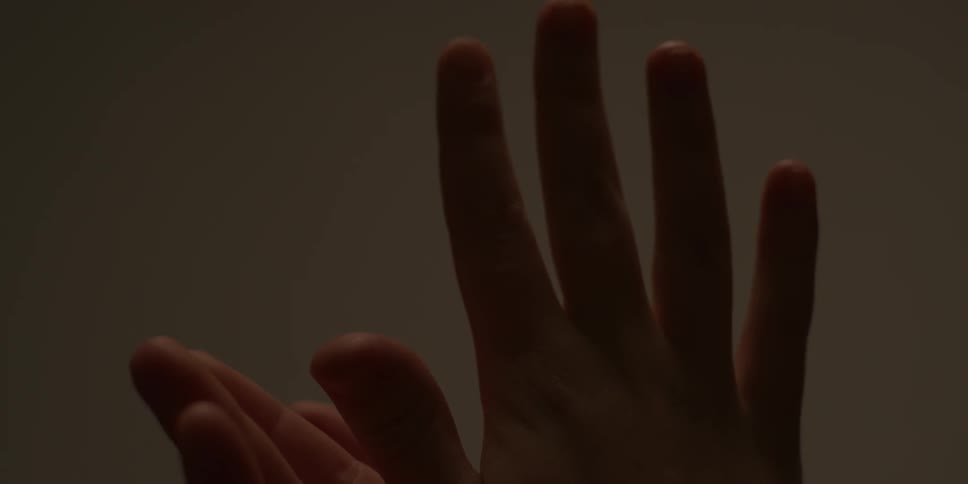 A person rubs their hands and clasps them