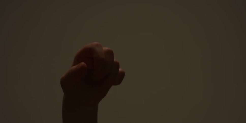A woman twists and turns her hand in the air
