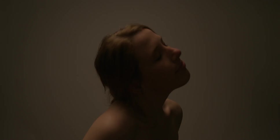 A naked woman is rolling her head and moving her arms
