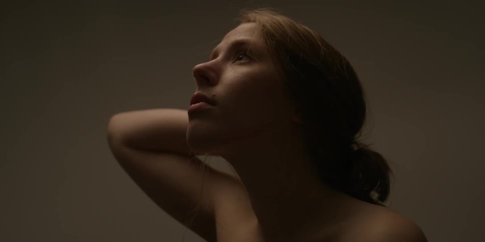 A woman stretches her arm up over her head