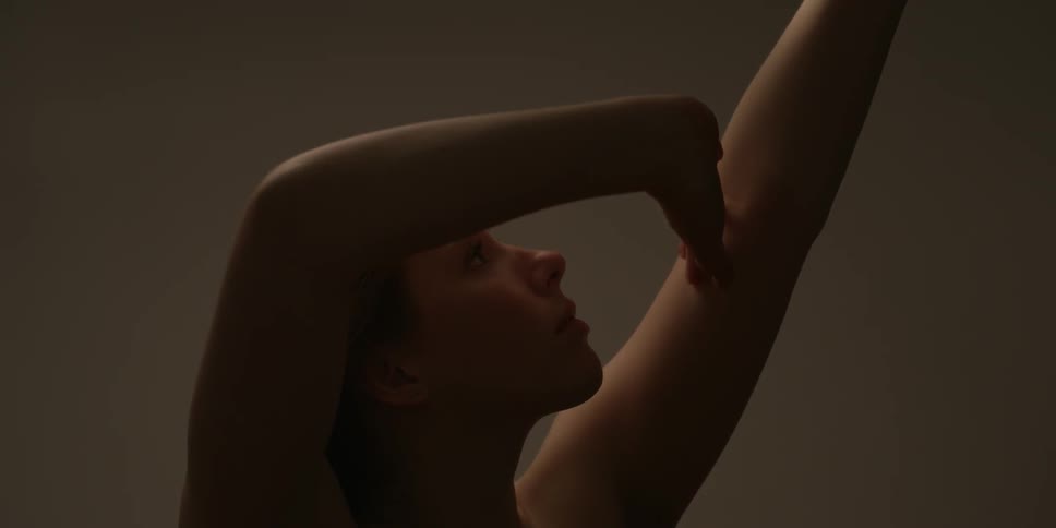 A naked woman is extending an arm and touching it