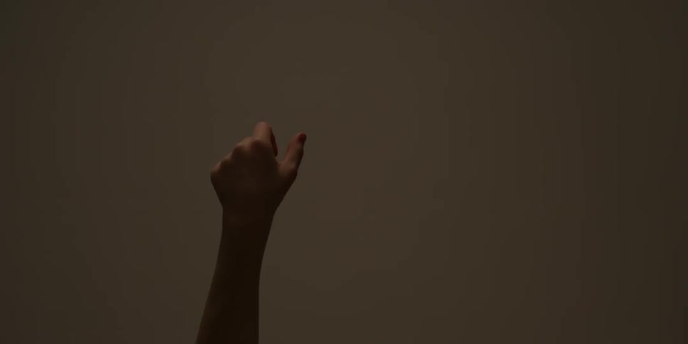Hand reaches up with nothing in the background