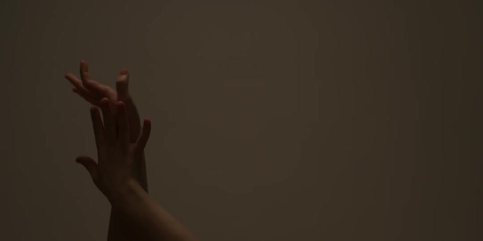 A person clasps their hands and leaves one up