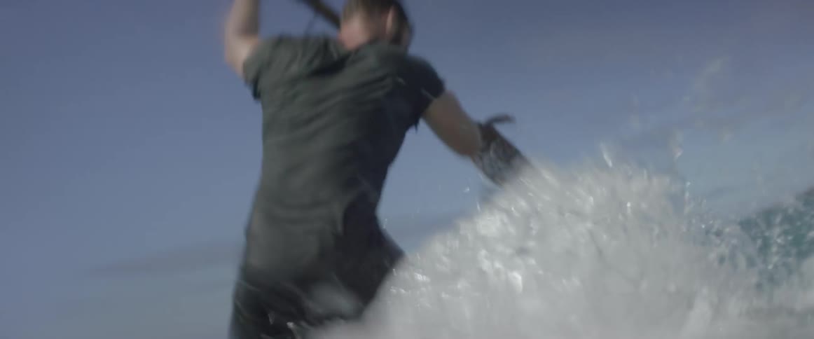 A man is rowing on a small wooden raft